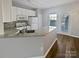 Bright kitchen featuring white cabinets, stainless steel appliances, and granite countertops at 10462 Trolley Run Dr, Cornelius, NC 28031