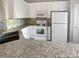 Functional kitchen featuring white cabinets, stainless steel appliances, and granite countertops at 10462 Trolley Run Dr, Cornelius, NC 28031