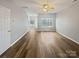Spacious living room with hardwood floors, a ceiling fan, and a view into the entryway at 10462 Trolley Run Dr, Cornelius, NC 28031