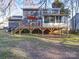 Spacious backyard with a large wooden deck and screened sunroom attached to home at 10929 Lassen Ct, Charlotte, NC 28214