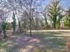 Expansive backyard with mature trees offering shade, and ample space for activities at 10929 Lassen Ct, Charlotte, NC 28214