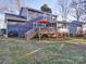 A spacious backyard with a deck that includes patio furniture and an umbrella at 10929 Lassen Ct, Charlotte, NC 28214