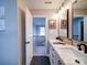 Bathroom with a double sink vanity, black hexagon tile flooring, and staircase access at 10929 Lassen Ct, Charlotte, NC 28214