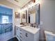 Bright bathroom featuring a double vanity with marble countertop and modern fixtures at 10929 Lassen Ct, Charlotte, NC 28214