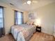 Inviting bedroom featuring a queen bed, stylish bedding, and a window with natural light at 10929 Lassen Ct, Charlotte, NC 28214