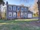 Charming two-story home featuring gray siding, a bright orange front door, and a well-maintained lawn at 10929 Lassen Ct, Charlotte, NC 28214