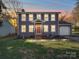 Charming two-story home featuring gray siding, a bright orange front door, and a well-maintained lawn at 10929 Lassen Ct, Charlotte, NC 28214