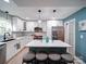 Modern kitchen with white cabinetry, a center island with seating, and stainless steel appliances at 10929 Lassen Ct, Charlotte, NC 28214