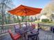 Outdoor deck with a patio table and umbrella surrounded by a lush green yard at 10929 Lassen Ct, Charlotte, NC 28214