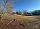 Large backyard with trees and sunny blue skies at 110 Amber Ln, Statesville, NC 28677