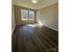 Bedroom with wood-look flooring, neutral paint, and natural light at 110 Amber Ln, Statesville, NC 28677