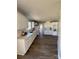 Bright kitchen featuring white cabinets, stainless appliances, a sink, and dark wood floors at 110 Amber Ln, Statesville, NC 28677
