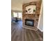 Open-concept living area with a stone fireplace feature and hardwood flooring throughout at 110 Amber Ln, Statesville, NC 28677