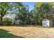 Spacious backyard with mature trees, sheds, and plenty of room for recreation at 112 Courtland St, Chester, SC 29706