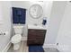 Bathroom features a modern vanity, round mirror, and sleek fixtures at 112 Courtland St, Chester, SC 29706