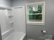 Bright bathroom features a modern tub, shower, and a window providing natural light at 112 Courtland St, Chester, SC 29706