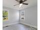 Clean and simple bedroom with neutral walls, two windows, ceiling fan, and modern grey flooring at 112 Courtland St, Chester, SC 29706