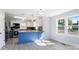 Bright and open kitchen layout with a blue center island and stainless steel appliances and grey floor at 112 Courtland St, Chester, SC 29706