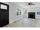 Bright living room features fresh paint, hardwood floors, a fireplace, and a decorative front door at 112 Courtland St, Chester, SC 29706