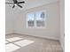 A bright bedroom features large windows and neutral carpeting at 117 Mills Garden Rd, Statesville, NC 28625