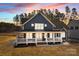 Stunning two-story home boasts a spacious porch, white trim, and a beautiful dusk sky backdrop at 117 Mills Garden Rd, Statesville, NC 28625