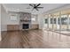 Inviting living room with fireplace, built-ins, wood floors, and sliding door access to the porch at 117 Mills Garden Rd, Statesville, NC 28625