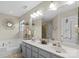 Bright bathroom showcasing double vanity, large mirror, and a separate tub, for a relaxing atmosphere at 11711 Royal Castle Ct, Charlotte, NC 28277