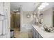 Well-lit bathroom features a shower, tub, double vanity, and ample counter space at 11711 Royal Castle Ct, Charlotte, NC 28277