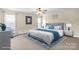 A well-lit bedroom boasts a spacious layout, complete with a ceiling fan, lots of light, and a decorative rug at 11711 Royal Castle Ct, Charlotte, NC 28277