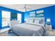 Inviting bedroom featuring a blue-and-white color scheme, large windows, and a comfortable bed at 11711 Royal Castle Ct, Charlotte, NC 28277