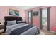 A staged bedroom features a plush bed with a padded headboard, complemented by neutral bedding and decor at 11711 Royal Castle Ct, Charlotte, NC 28277