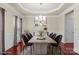 Stylishly staged dining room with modern table, seating, and elegant decor under a tray ceiling at 11711 Royal Castle Ct, Charlotte, NC 28277