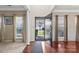 Elegant foyer showcasing gleaming hardwood floors, decorative columns, and abundant natural light at 11711 Royal Castle Ct, Charlotte, NC 28277