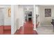 Hallway with hardwood floors leading to living room and staircase at 11711 Royal Castle Ct, Charlotte, NC 28277