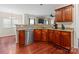 Bright kitchen features stainless steel appliances, granite countertops, and rich wood flooring at 11711 Royal Castle Ct, Charlotte, NC 28277