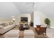 A bright living room with a large TV, plush sofa, and a neutral carpet for a calming effect at 11711 Royal Castle Ct, Charlotte, NC 28277
