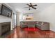 Spacious living room with a large sofa set, a red rug, and a fireplace with mounted TV at 11711 Royal Castle Ct, Charlotte, NC 28277