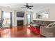 Living room with fireplace, ceiling fan, hardwood floors, and large sofa set at 11711 Royal Castle Ct, Charlotte, NC 28277