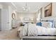 Light and airy main bedroom with tray ceilings, chandelier, and a comfortable sitting area at 126 Goorawing Ln, Mooresville, NC 28115