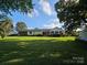 A sprawling backyard showcases a well-maintained lawn, a charming deck, and the home's rear exterior at 130 Scism Rd, Kings Mountain, NC 28086