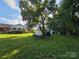 Lush backyard featuring a deck, shed and mature trees at 130 Scism Rd, Kings Mountain, NC 28086