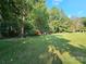 Expansive backyard featuring lush green lawn, mature trees, and a charming shed, perfect for outdoor enjoyment at 130 Scism Rd, Kings Mountain, NC 28086