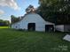 The white barn features an open bay door with a lawnmower inside and a grassy front lawn at 130 Scism Rd, Kings Mountain, NC 28086