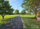 A private driveway is flanked with tree-lined grassy lawn at 130 Scism Rd, Kings Mountain, NC 28086