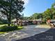 Charming brick home with a covered carport and spacious concrete parking pad at 130 Scism Rd, Kings Mountain, NC 28086