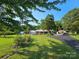 Beautiful home featuring a well-manicured lawn, mature trees, and a long driveway at 130 Scism Rd, Kings Mountain, NC 28086