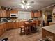 Well-maintained kitchen with wood cabinets, practical layout, and central island with seating at 130 Scism Rd, Kings Mountain, NC 28086