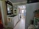 View of a laundry room featuring a deep sink, neutral tile floor, and white cabinets at 130 Scism Rd, Kings Mountain, NC 28086