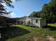 A shed with fresh siding sits next to a truck and an outdoor seating area at 130 Scism Rd, Kings Mountain, NC 28086