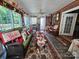 Bright sunroom with brick and stone flooring featuring a dining table, large windows, and festive decor at 130 Scism Rd, Kings Mountain, NC 28086